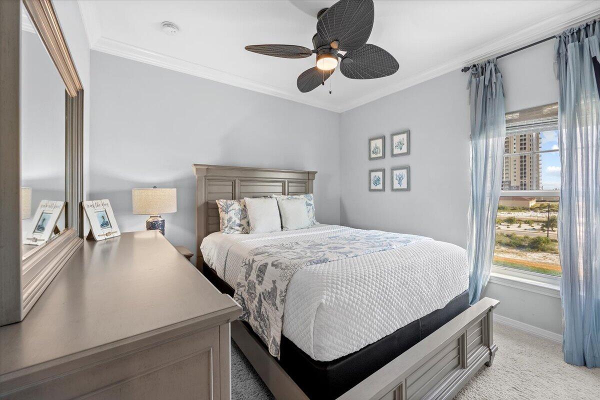 14241 Beach Heather Court Perdido Key, FL 32507 - Photo 32 of 39 a bedroom with a large bed and a chandelier