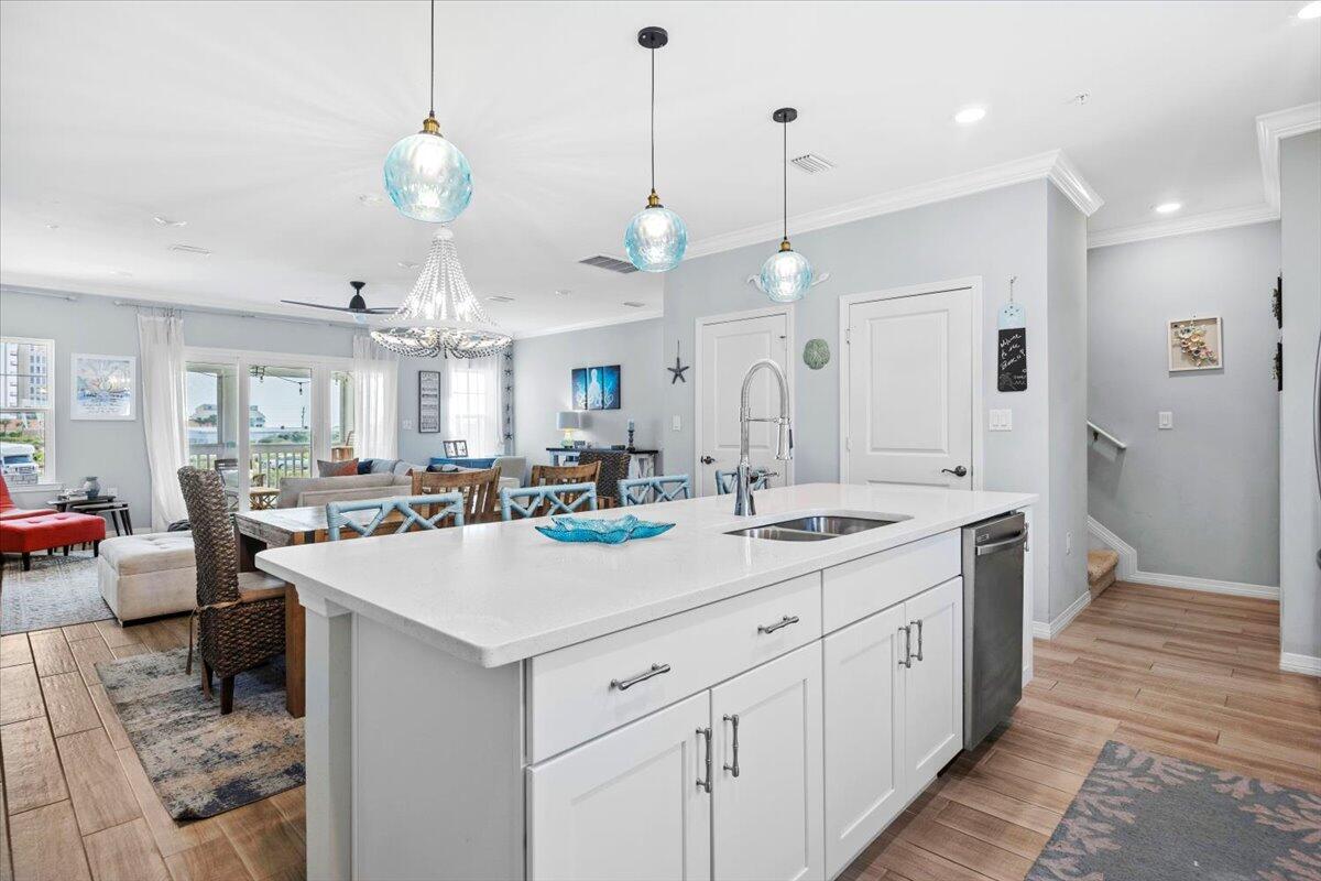 14241 Beach Heather Court Perdido Key, FL 32507 - Photo 10 of 39 a large kitchen with kitchen island a stove a sink a center island a dining table and chairs