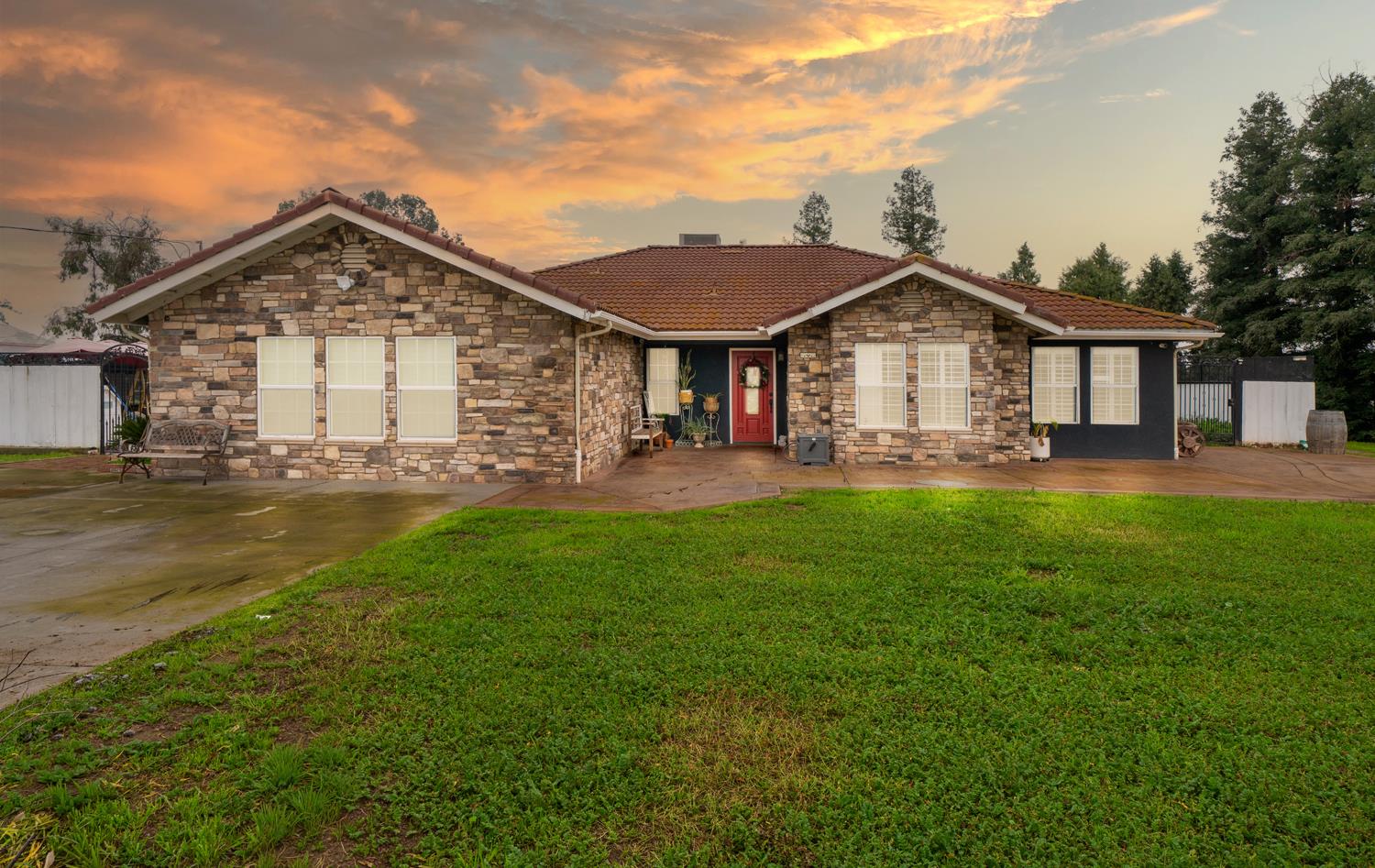 31144 James Avenue Madera, CA 93636 - Photo 1 of 45 a front view of a house with a yard and trees