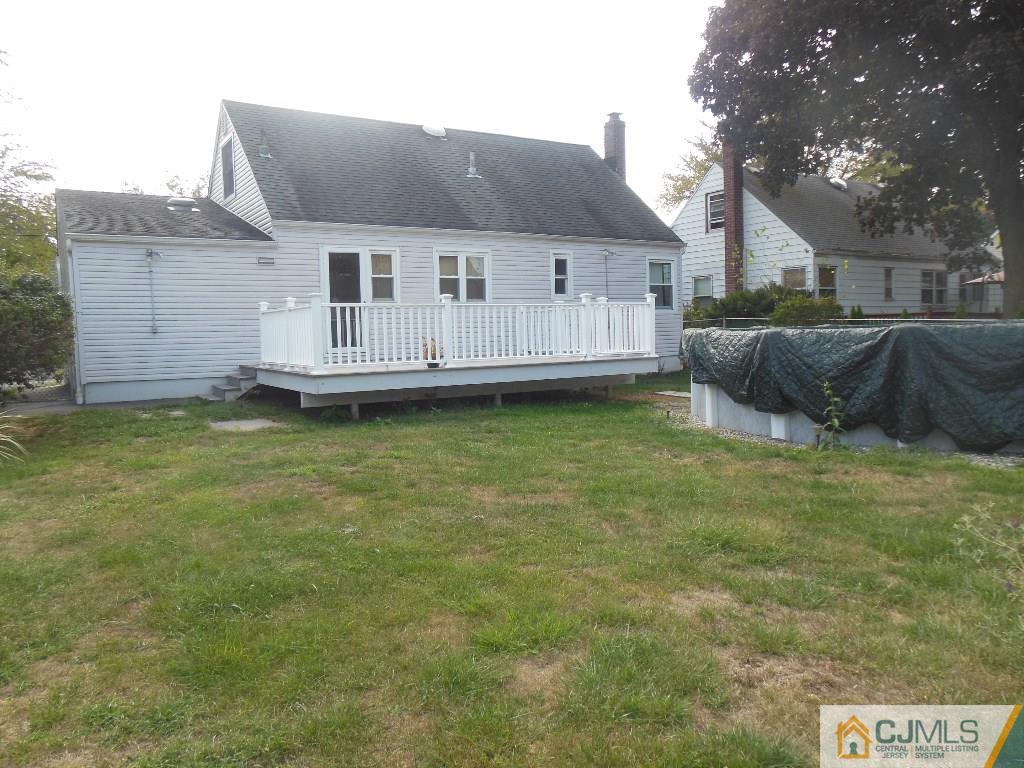 514 Fairway Road Linden, NJ 07036 - Photo 15 of 16 a front view of a house with a garden and yard