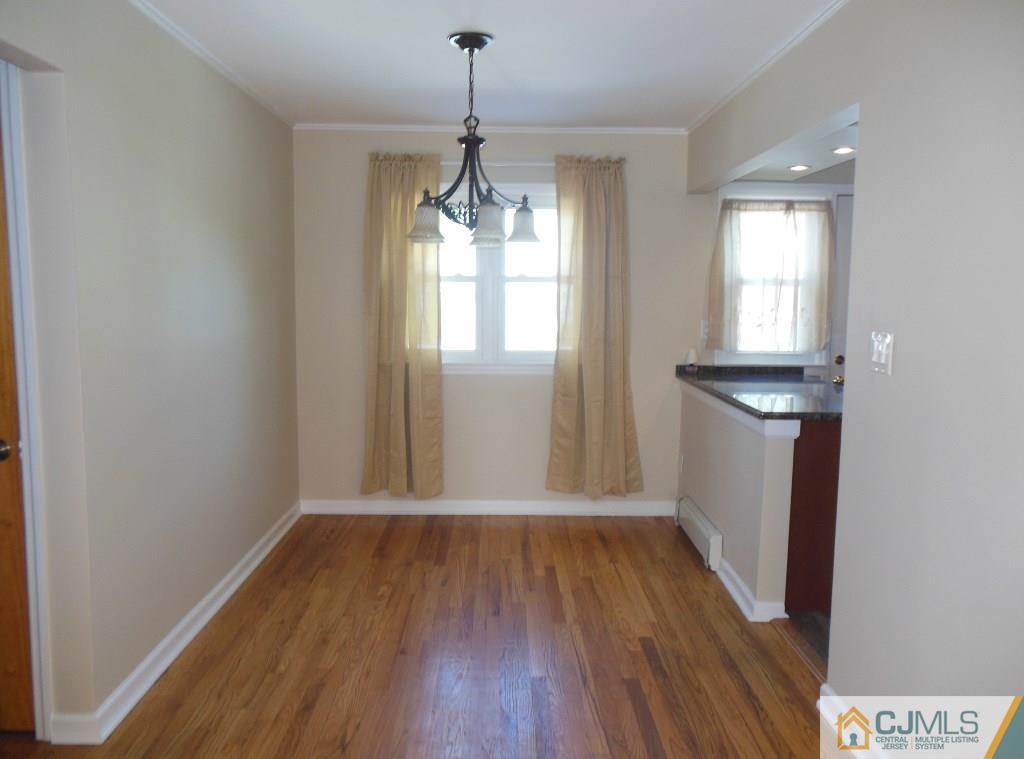 514 Fairway Road Linden, NJ 07036 - Photo 3 of 16 a view of empty room with wooden floor and fan