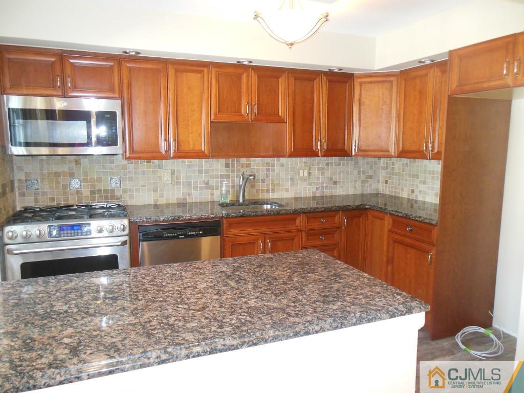 514 Fairway Road Linden, NJ 07036 - Photo 4 of 16 a kitchen with stainless steel appliances granite countertop a sink and a granite counter tops