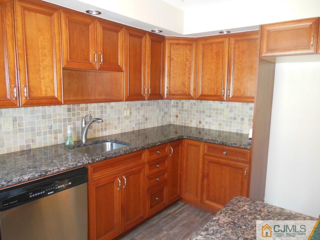 514 Fairway Road Linden, NJ 07036 - Photo 6 of 16 a kitchen with stainless steel appliances granite countertop a sink a refrigerator and cabinets