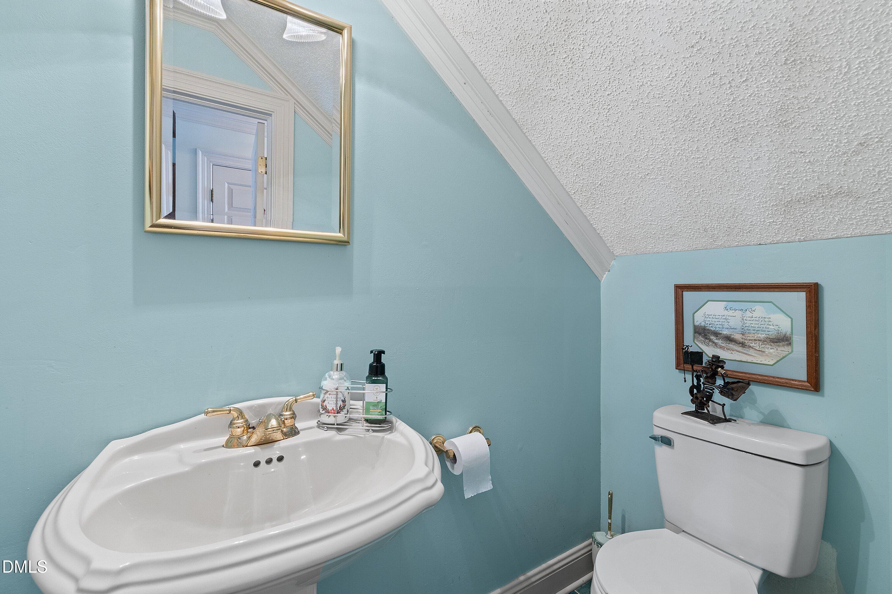 6314 Old Davis Road Sims, NC 27880 - Photo 14 of 71 a bathroom with a toilet sink and mirror