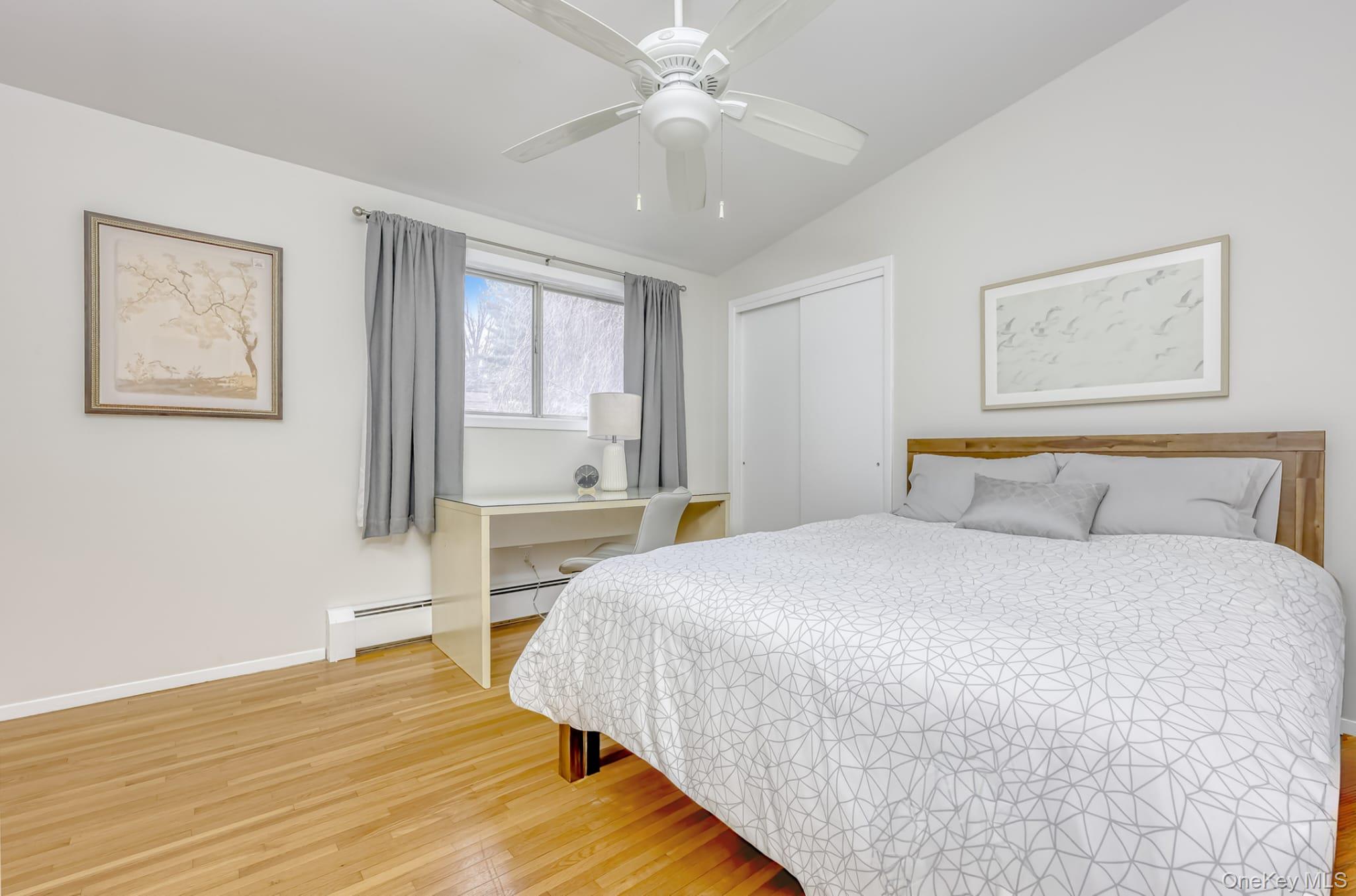 12 Woodwind Lane Spring Valley, NY 10977 - Photo 11 of 27 a bedroom with a large bed and a chandelier