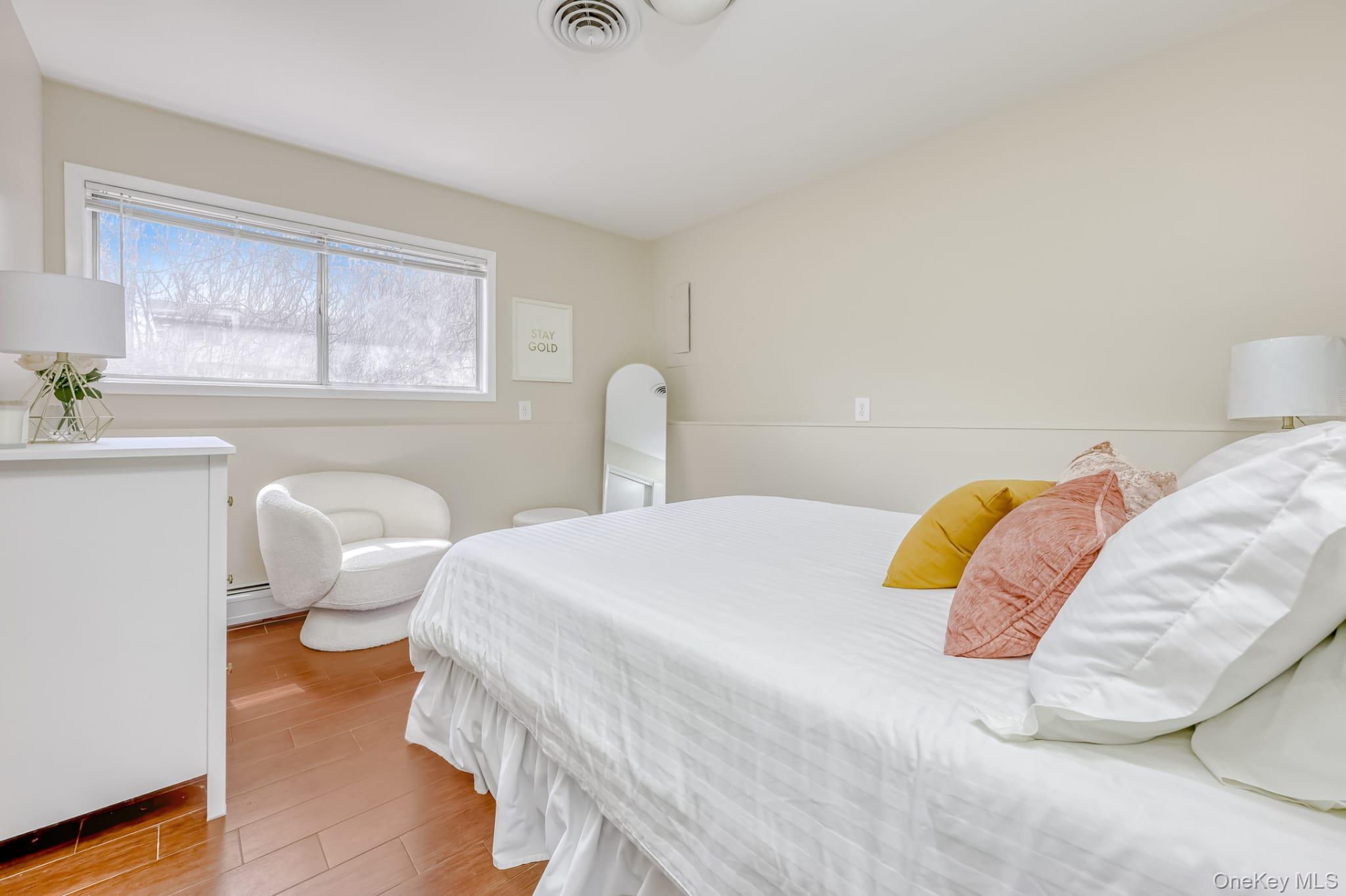 12 Woodwind Lane Spring Valley, NY 10977 - Photo 12 of 27 a bedroom with a bed and wooden floor