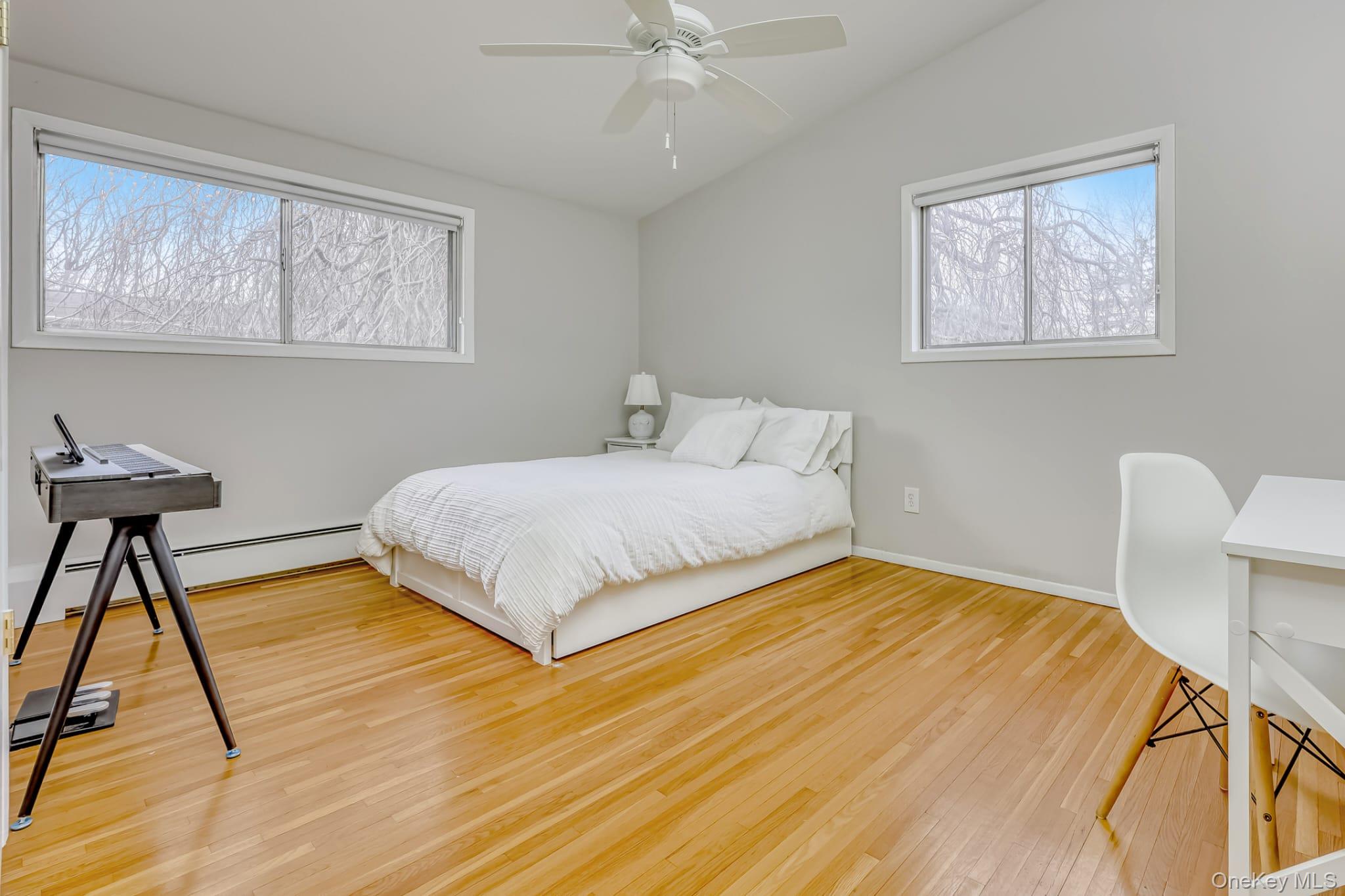 12 Woodwind Lane Spring Valley, NY 10977 - Photo 13 of 27 a bedroom with a bed a table and chair