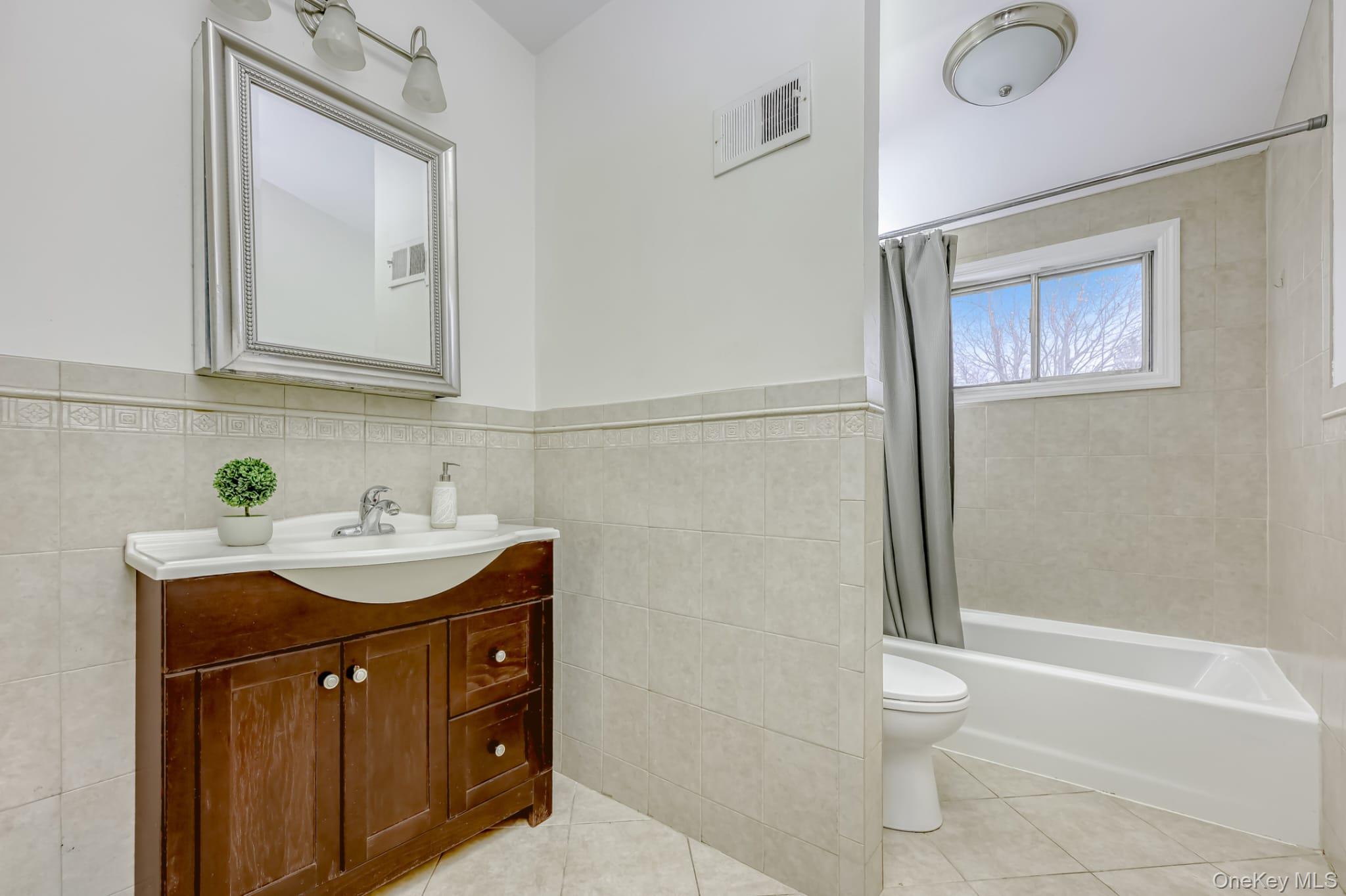 12 Woodwind Lane Spring Valley, NY 10977 - Photo 15 of 27 a bathroom with a sink a toilet and shower