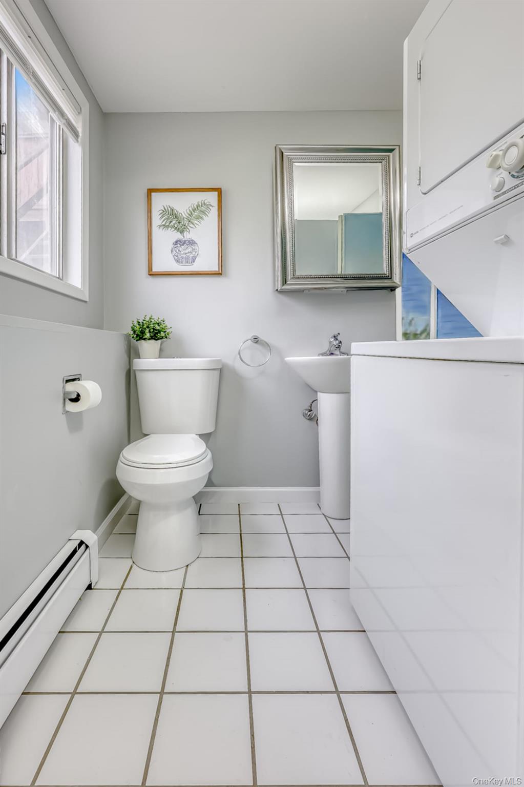 12 Woodwind Lane Spring Valley, NY 10977 - Photo 19 of 27 a bathroom with a toilet a sink and mirror