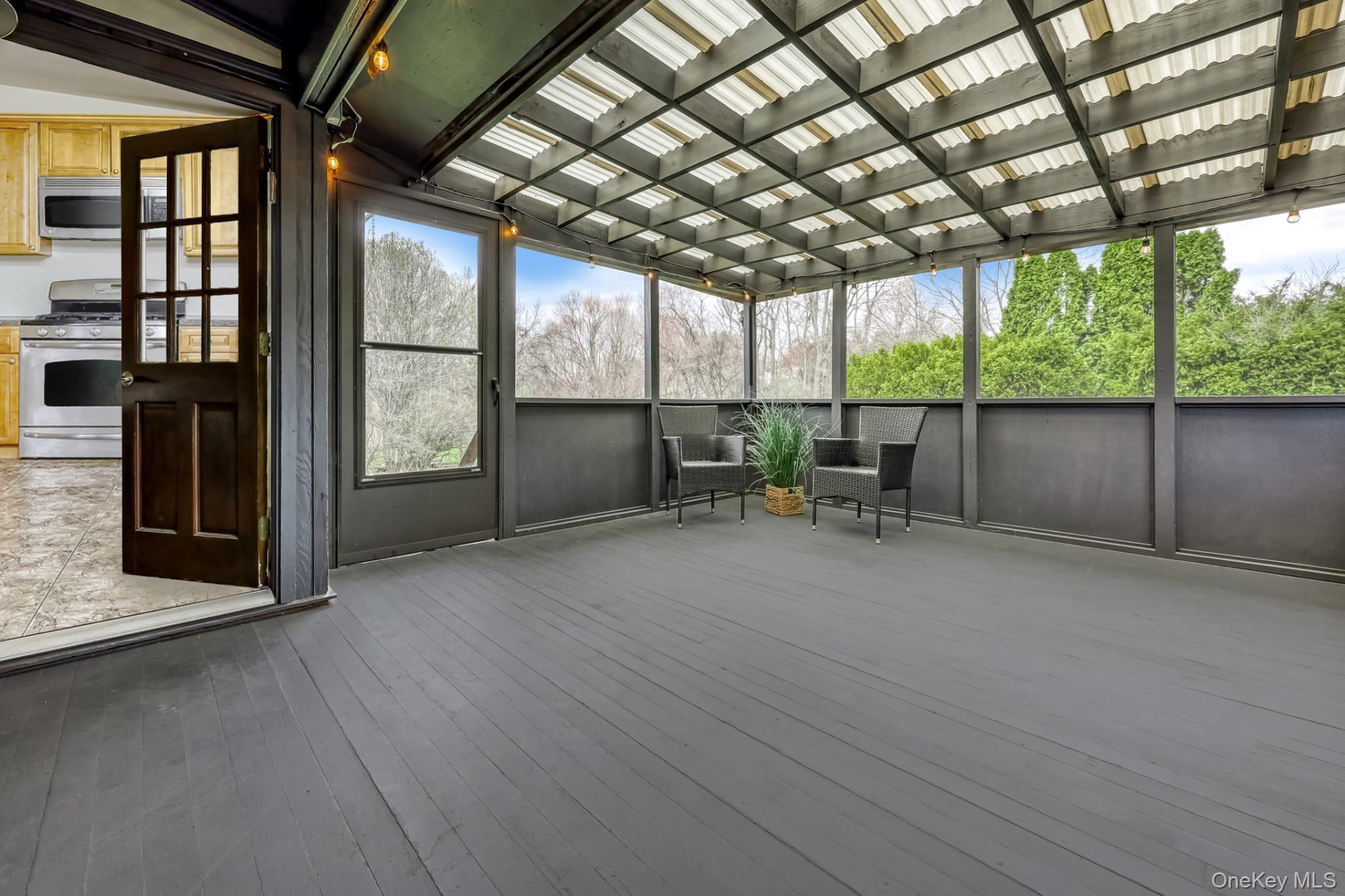 12 Woodwind Lane Spring Valley, NY 10977 - Photo 20 of 27 a view of a porch with furniture and floor to ceiling window
