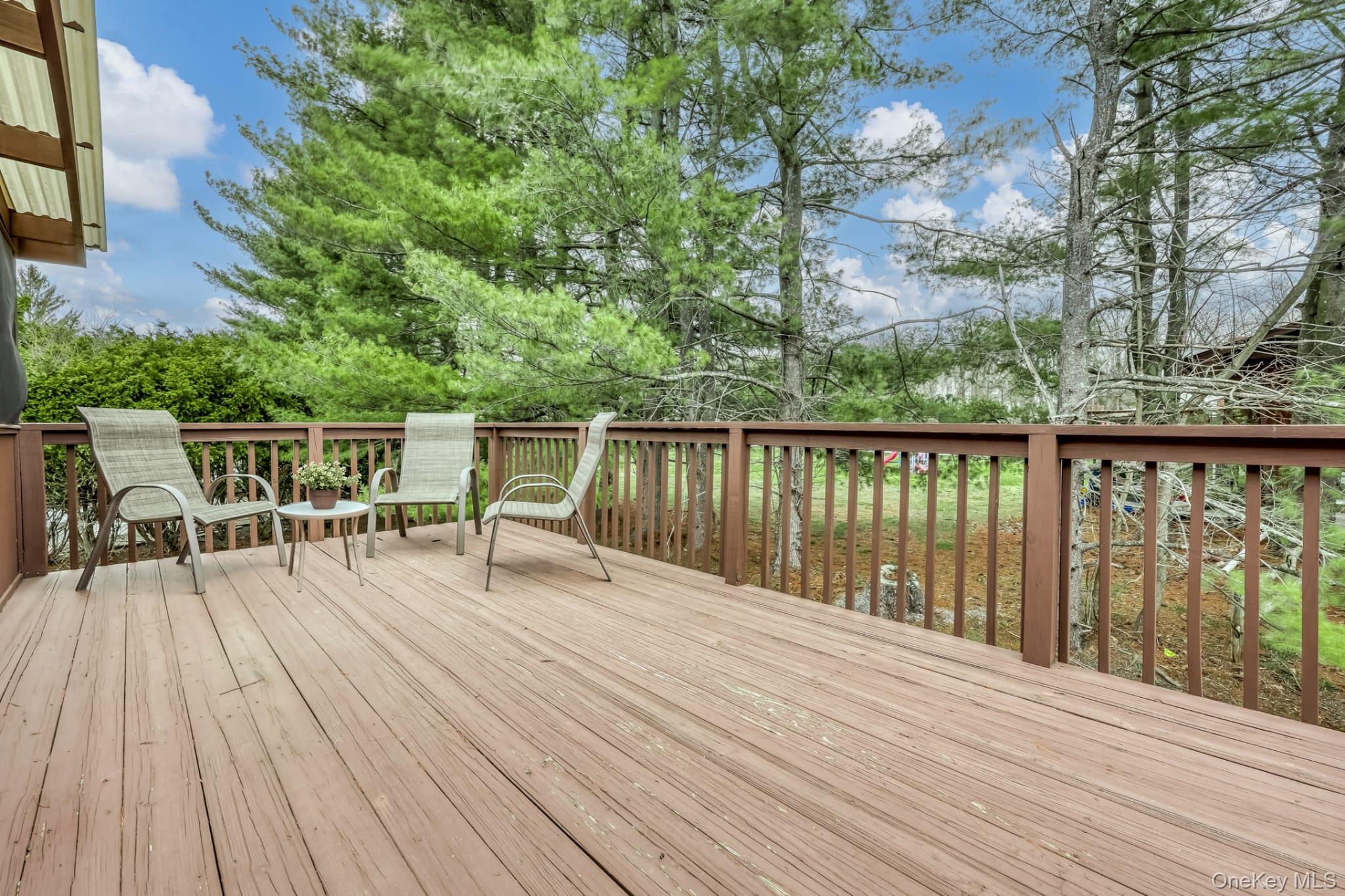 12 Woodwind Lane Spring Valley, NY 10977 - Photo 21 of 27 a balcony with wooden floor table and chairs