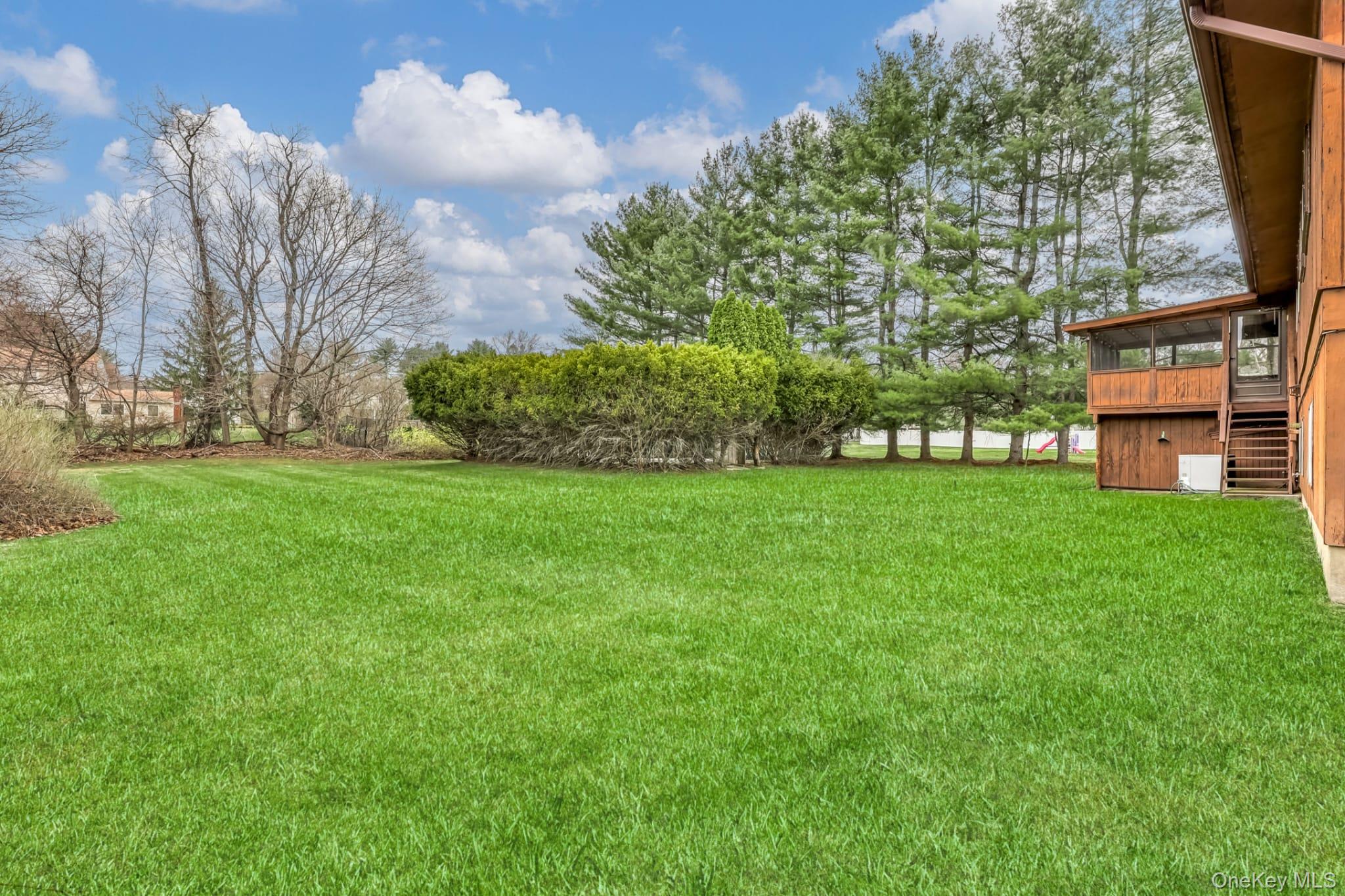 12 Woodwind Lane Spring Valley, NY 10977 - Photo 23 of 27 a view of a big yard with plants and large trees