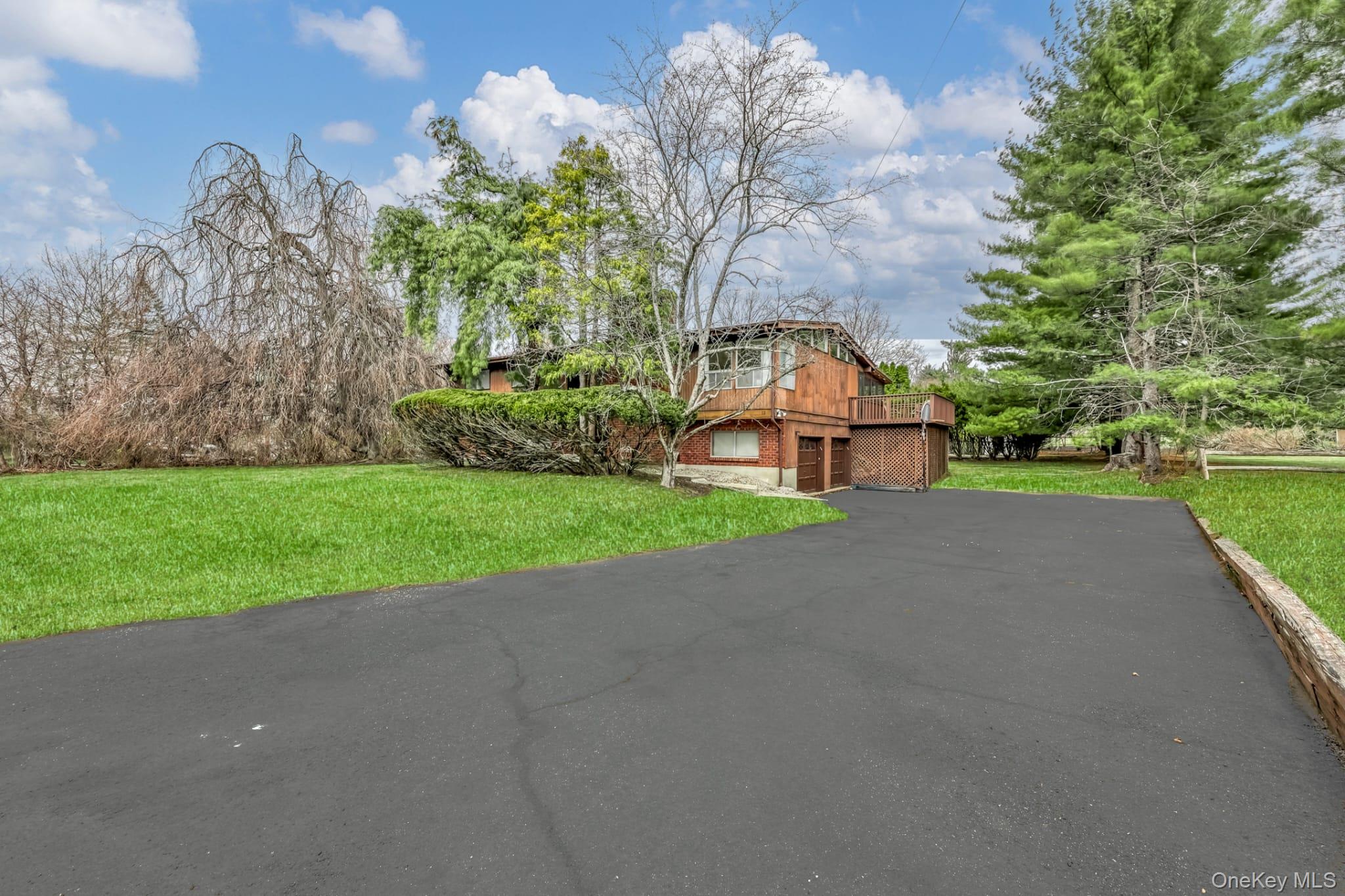 12 Woodwind Lane Spring Valley, NY 10977 - Photo 25 of 27 a view of a house with a yard and large trees