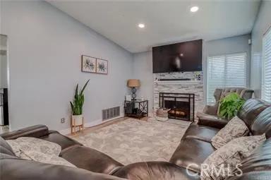 a living room with furniture fireplace and a flat screen tv