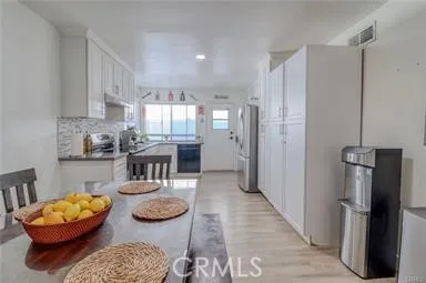 a kitchen with stainless steel appliances granite countertop a refrigerator and a stove