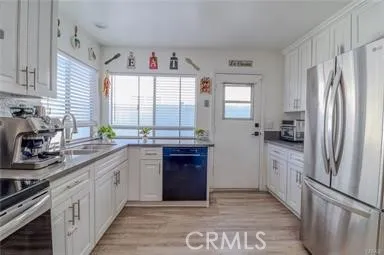 a kitchen with a refrigerator sink and windows