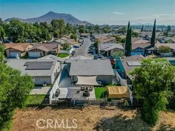 an aerial view of multiple houses with a yard