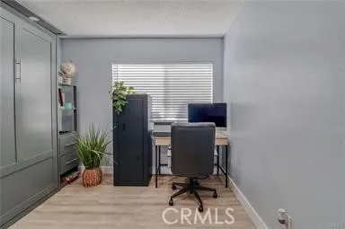 a view of a workspace with furniture and a potted plant