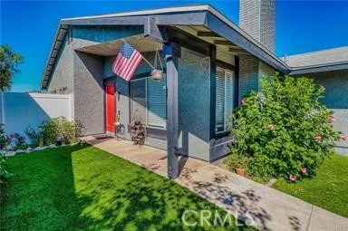 a view of a house with a small yard and plants