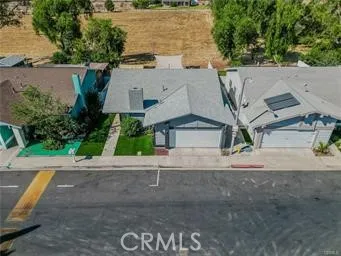 an aerial view of a house with a yard and potted plants