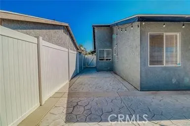 a view of a house with a wooden fence
