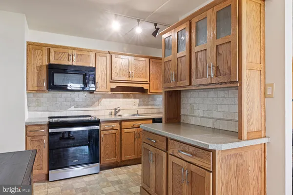 a kitchen with stainless steel appliances granite countertop a stove and a sink