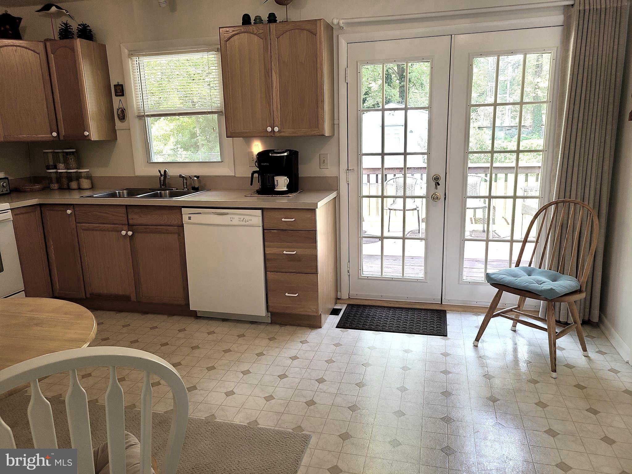 French doors in kitchen open to deck and backyard