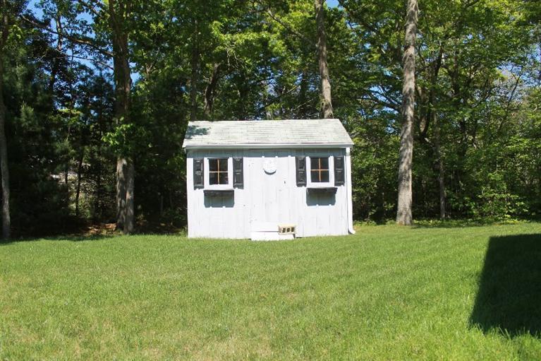 1344 Shootflying Hill Road Centerville, MA 02632 - Photo 14 of 18 a front view of a house with a yard