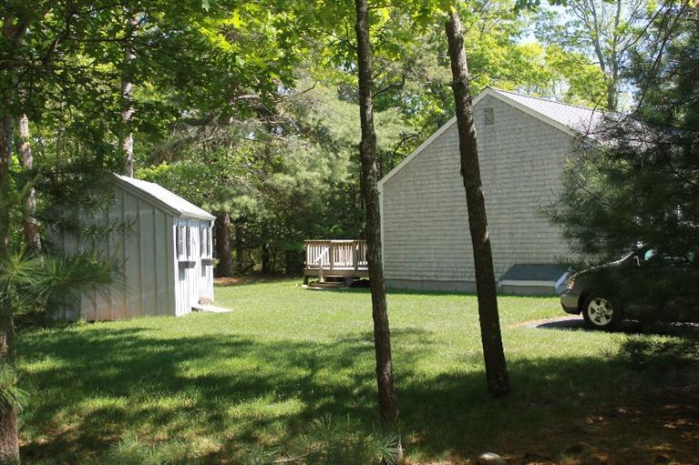 1344 Shootflying Hill Road Centerville, MA 02632 - Photo 15 of 18 a backyard of a house with lots of green space