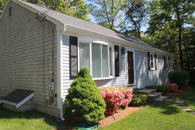 1344 Shootflying Hill Road Centerville, MA 02632 - Photo 18 of 18 a front view of a house with a yard