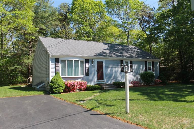 1344 Shootflying Hill Road Centerville, MA 02632 - Photo 2 of 18 a front view of a house with garden