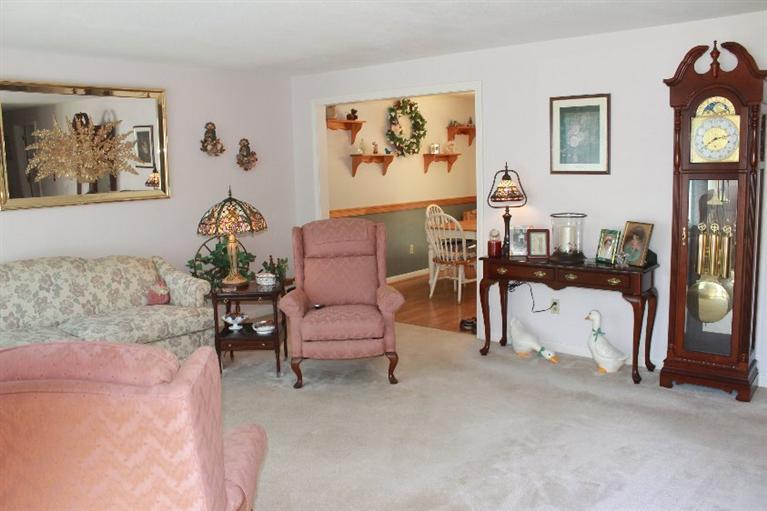 1344 Shootflying Hill Road Centerville, MA 02632 - Photo 7 of 18 a living room with furniture and a painting on the wall