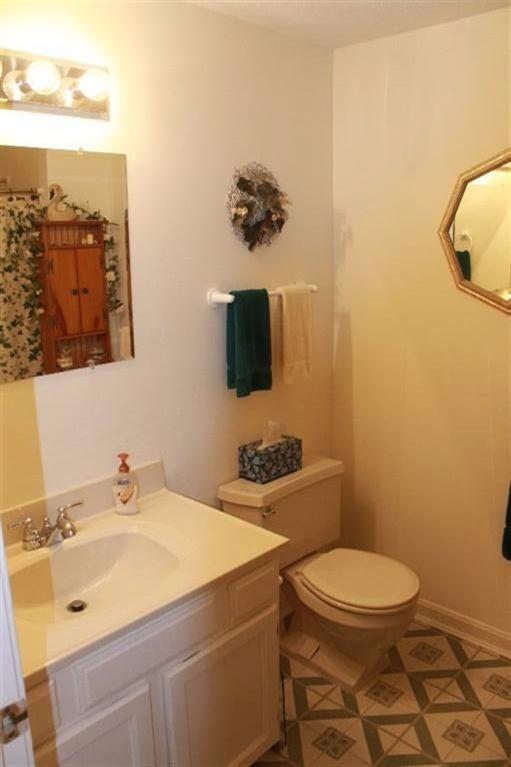 1344 Shootflying Hill Road Centerville, MA 02632 - Photo 8 of 18 a bathroom with a sink a toilet and mirror