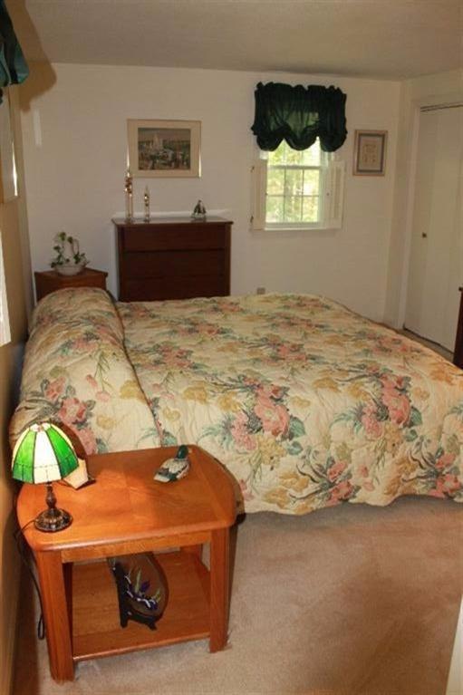 1344 Shootflying Hill Road Centerville, MA 02632 - Photo 10 of 18 a bedroom with a bed and a bed