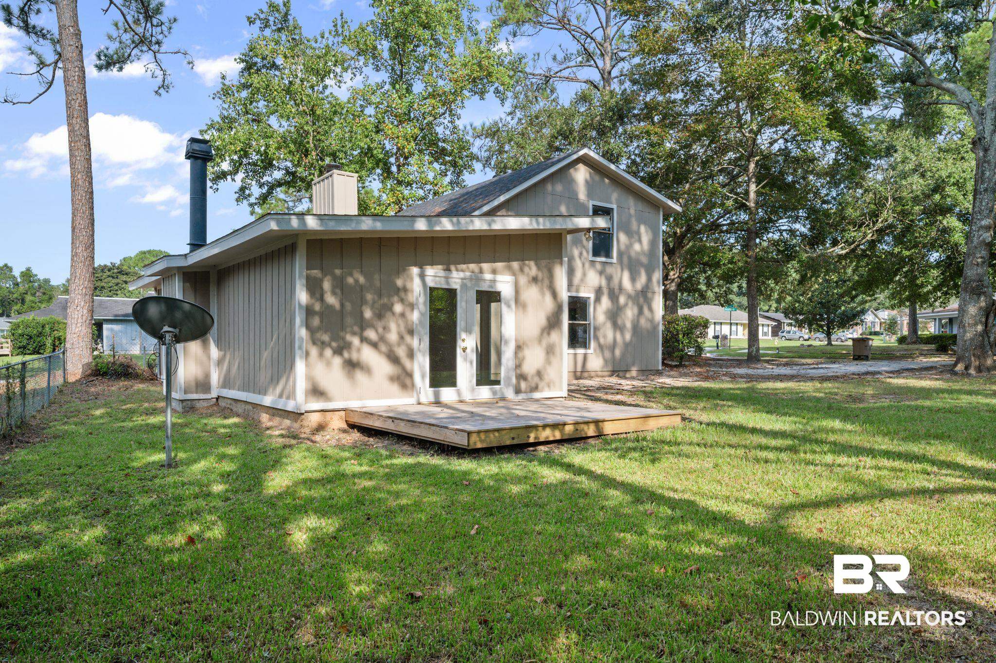 3701 Vista Ridge Drive Mobile, AL 36693 - Photo 6 of 33 Back of house with a deck and a yard