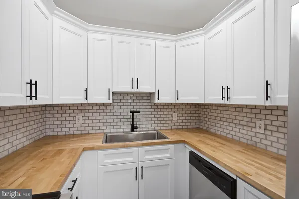 a kitchen with a sink and cabinets