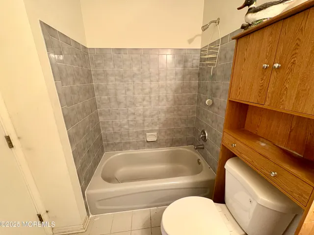 a view of a room with wooden floor and windows