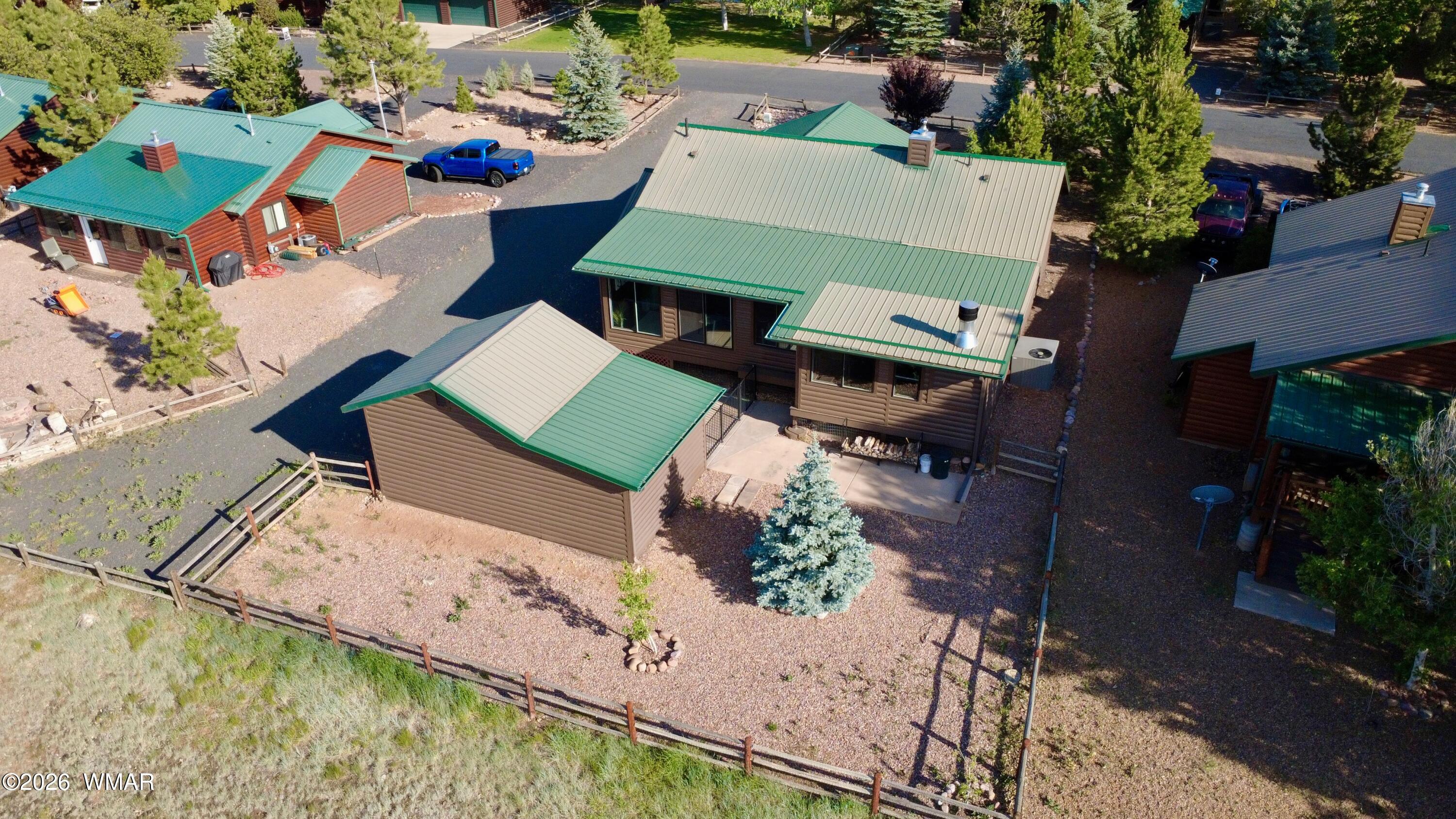 2334 Buffalo Loop Overgaard, AZ 85933 - Photo 3 of 25 an aerial view of a house with a garden and lake view