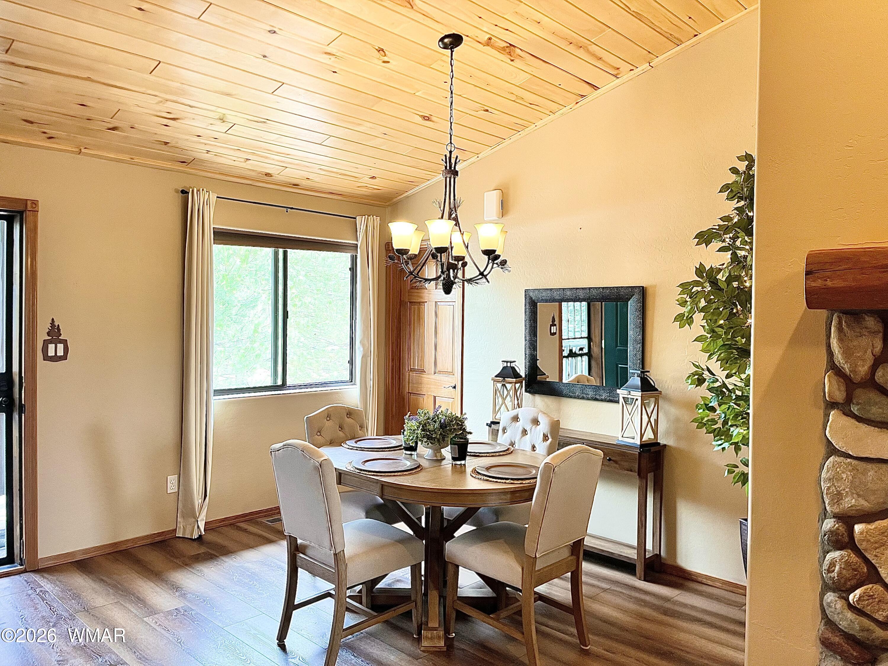 2334 Buffalo Loop Overgaard, AZ 85933 - Photo 5 of 25 a view of a dining room with furniture window and wooden floor