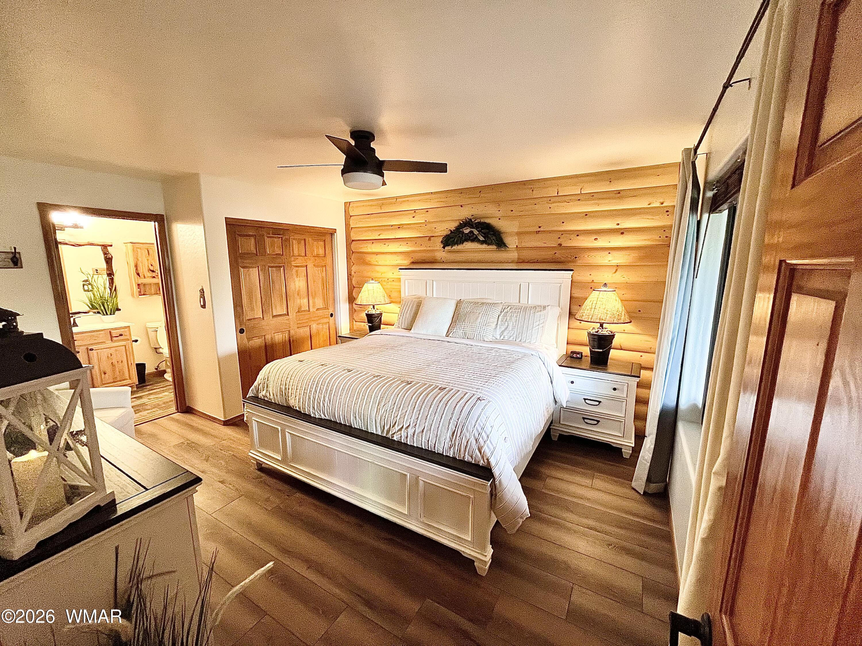 2334 Buffalo Loop Overgaard, AZ 85933 - Photo 7 of 25 a spacious bedroom with a bed and wooden floor