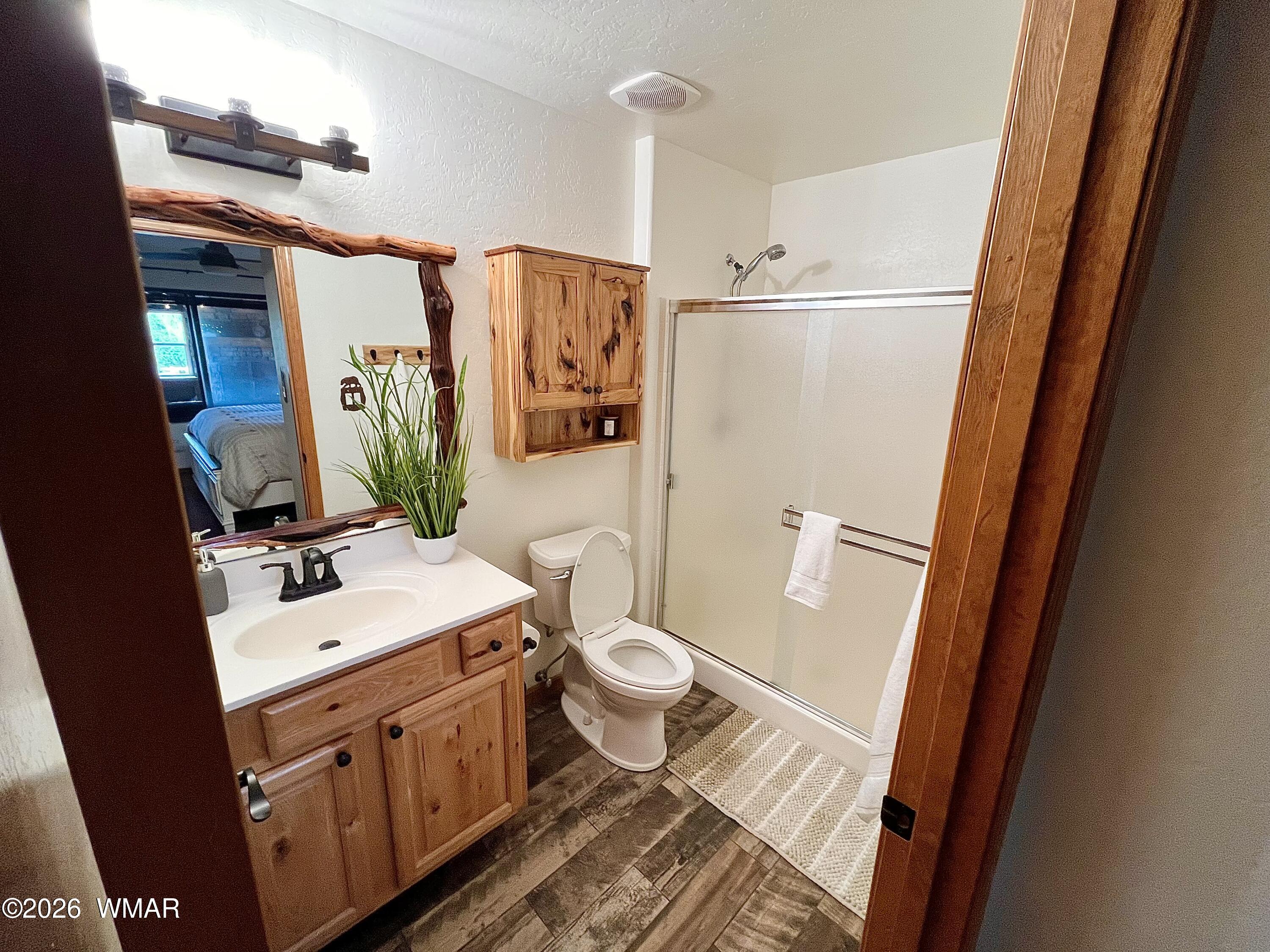 2334 Buffalo Loop Overgaard, AZ 85933 - Photo 8 of 25 a bathroom with a sink a toilet a mirror and shower