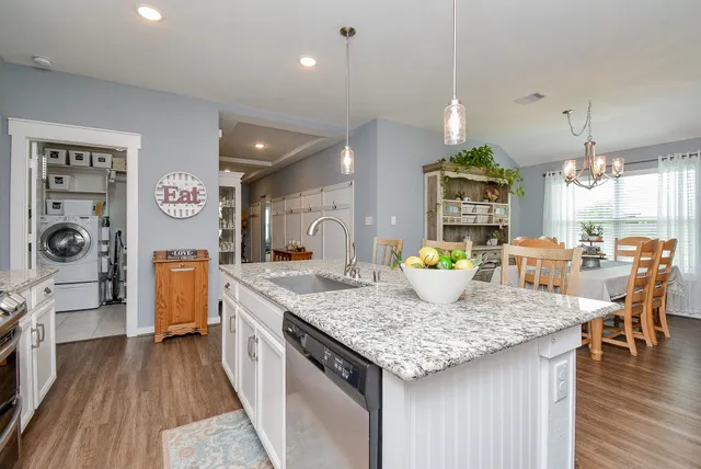 a kitchen with a table chairs refrigerator and microwave
