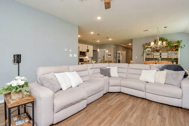 a living room with furniture and a fireplace