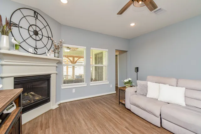 a living room with furniture a fireplace and a flat screen tv