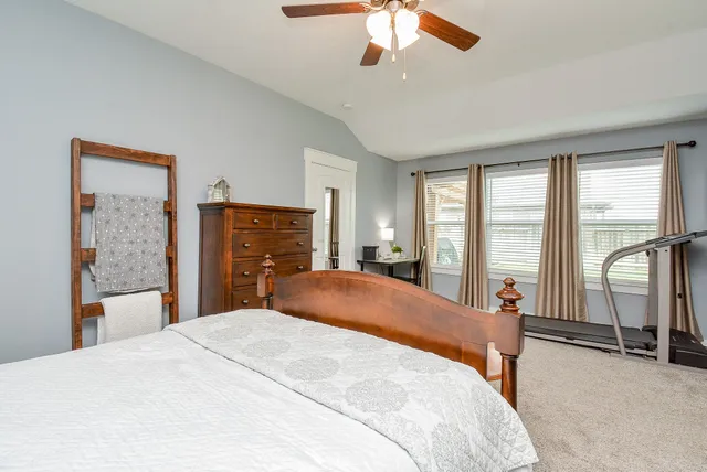 a bedroom with a large bed and a large window