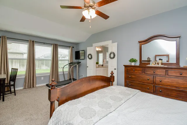 a bathroom with a granite countertop sink a mirror and a bathtub