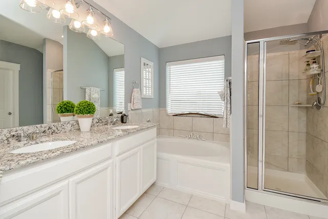 a bathroom with a bathtub and a shower