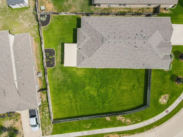 an aerial view of a residential houses with outdoor space
