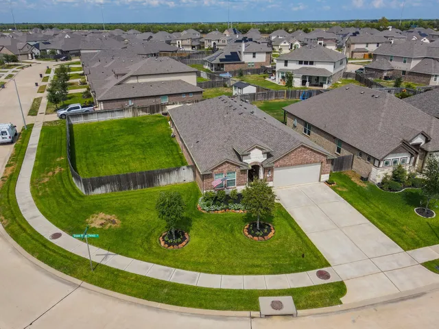 an aerial view of residential houses with outdoor space