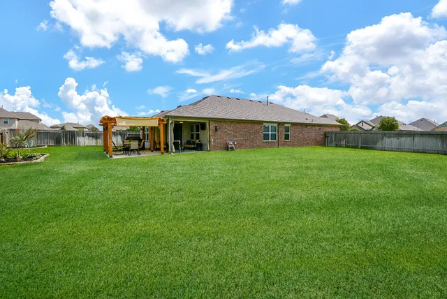 a front view of a house with a garden and yard